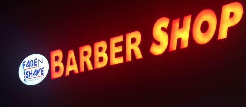 Fade N' Shave Barber Shop storefront at night on Peoria St in Aurora CO